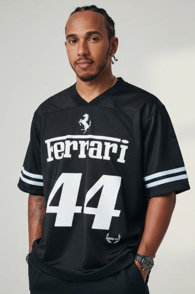 Person wearing a black Ferrari jersey with number 44 on a plain background
